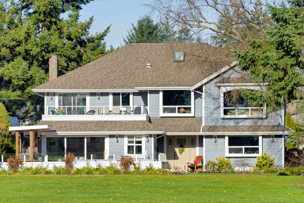 Luxury residential house with big green lawn on the back yard