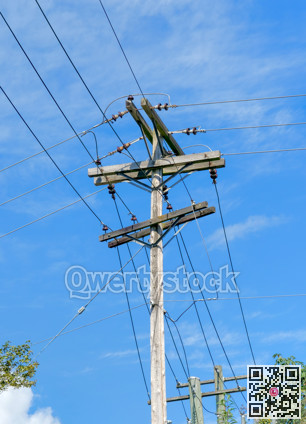 Electric pole and wires, wood electricty pole on blue sky background.
