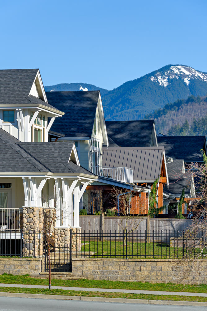 Row of residential houses with mountain and blue sky background