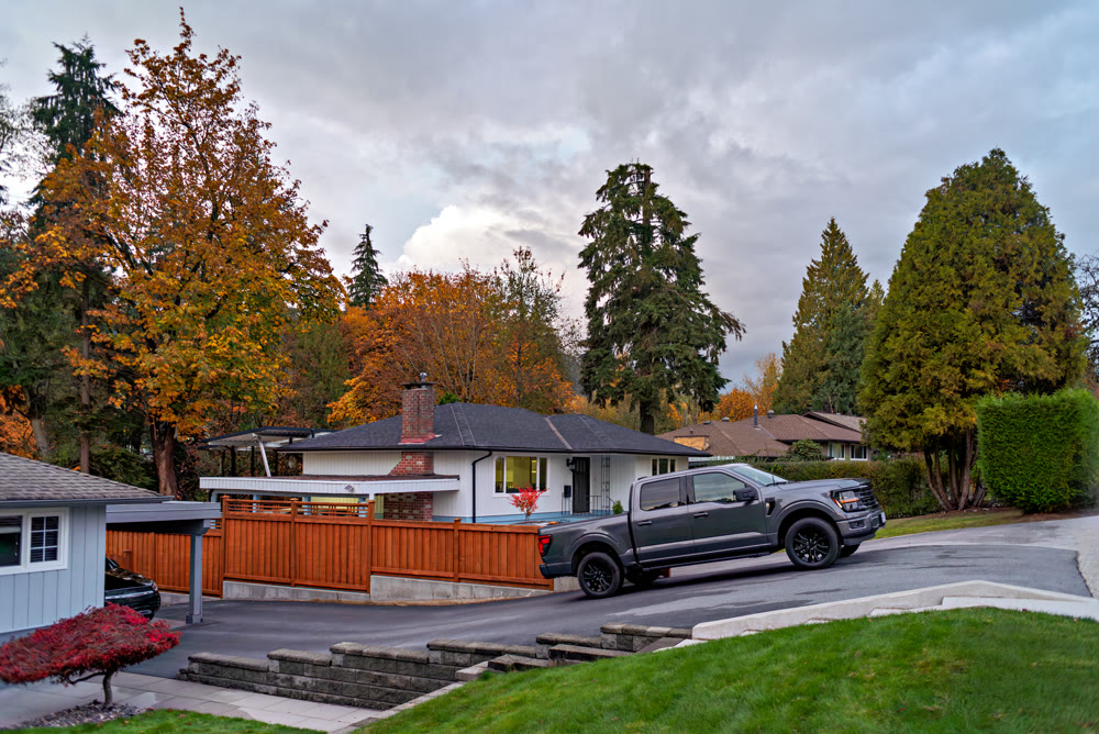 Autumn in residential area with a truck parked on uphil driveway