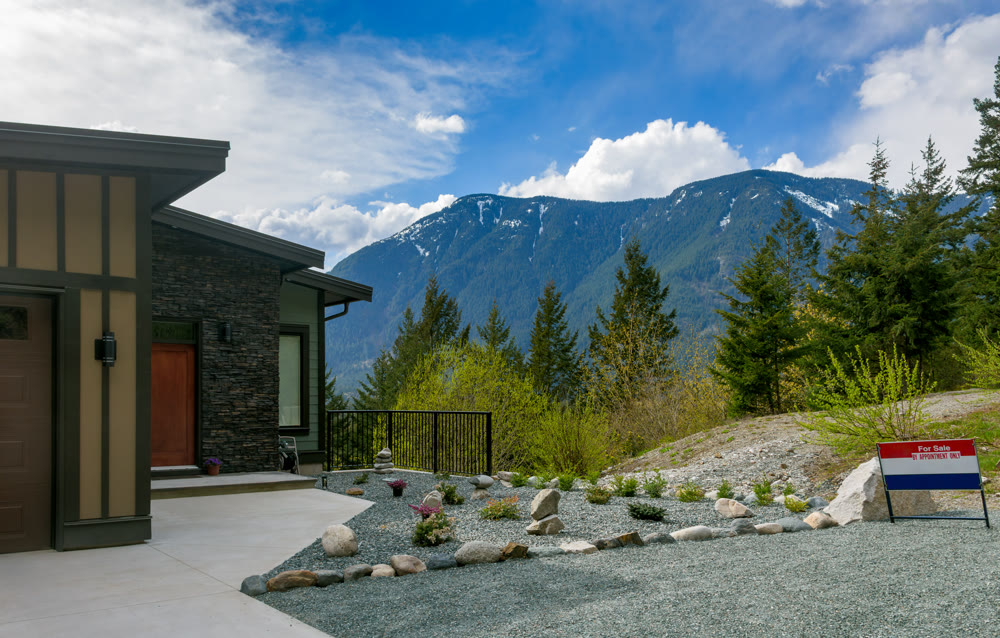 Entrance of residential house on snow mountain and cloudy blue sky background