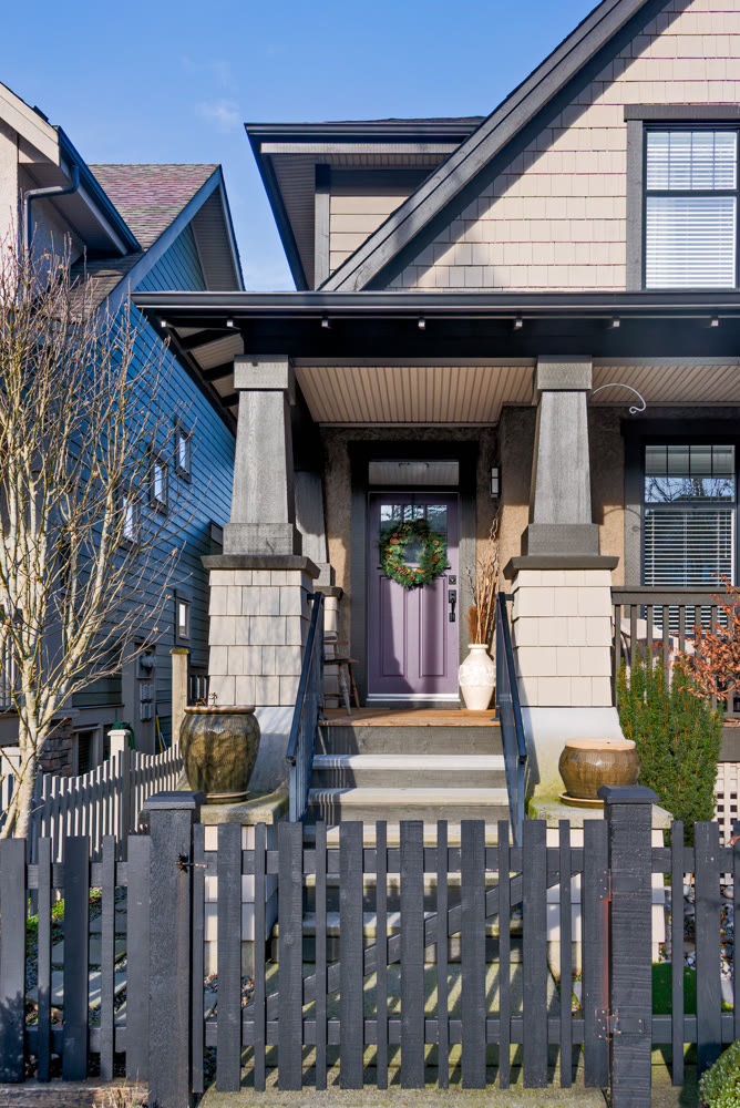 Residential house entrantrance with purple door decorated for Christmas season