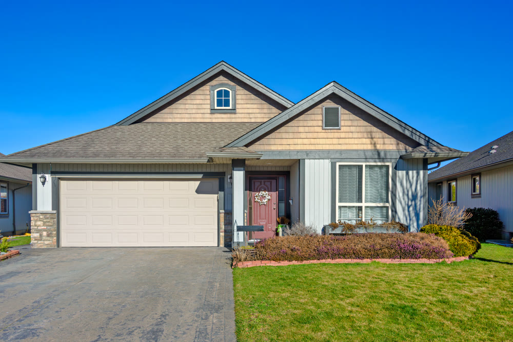 Wide garage of a nice residential house on bright winter day in British Columbia, Canada