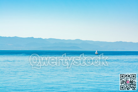 Seascape with the sail yacht in Pacific ocean bay