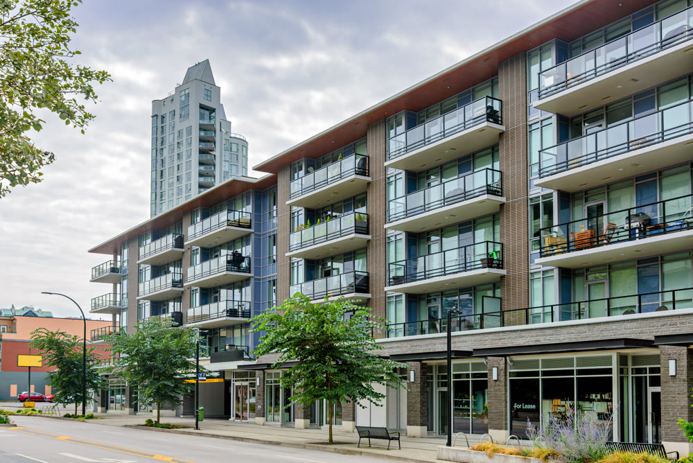 Low-rise and high-rise residential buildings with shops and offices along the street