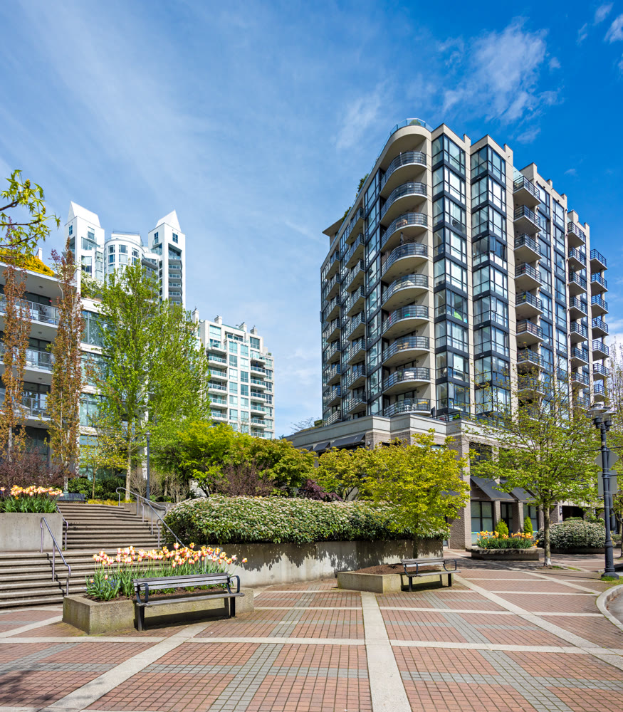 Modern residential high-rise buildings and landscaped public plaza in spring
