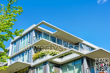 Top of residential building on blue sky background