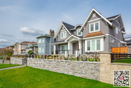 Luxury residential houses with landscaped front yard on land terrace.