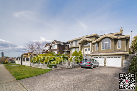 Luxury residential houses with a car in front on cloudy day in Vancouver, Canada