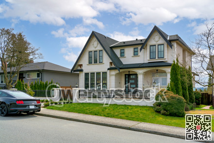 Luxury residential house with a car parked in front on cloudy day