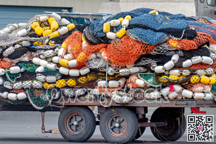 Trawler fishing net and floats stored on a trailer