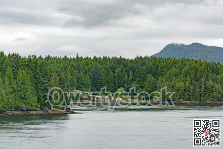 Pacific ocean bay overview with residential house on the shore