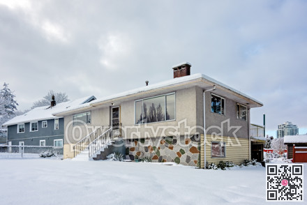 Average residential houses in snow on overcast sky background