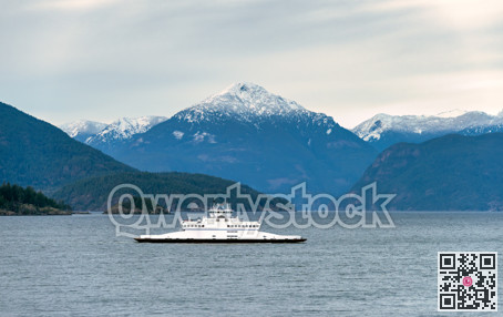 Smaller ferry vessel going by Pacific ocean bay