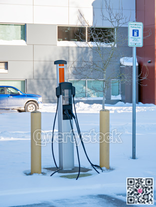 EV charging station on winter season with gas truck parked nearby