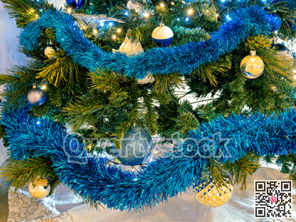 Blue and golden baubles on pine tree brenches. Christmas decorations