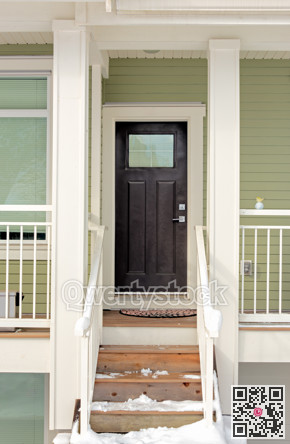 Entrance door of residential townhouse with doorsteps in snow