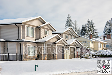 Residential duplex house in snow on winter day in Coquitlam, BC, Canada