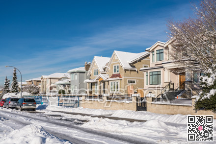 Street of brand new luxury houses on blue sky background in winter