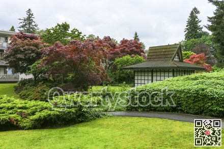 Paved pathway over small park in residential area