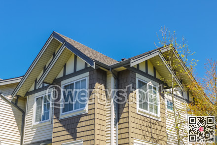 Roof of new townhouses on blue sky background