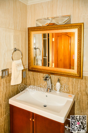 Hands wash basin with the mirror in a bathroom of luxury house