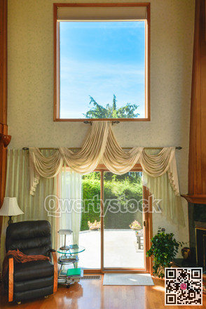 High ceiling beautiful living room interior with hardwood floor