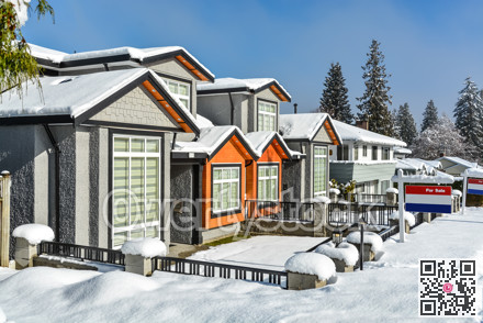 New family home for sale. New house in the suburbs on a sunny winter day.
