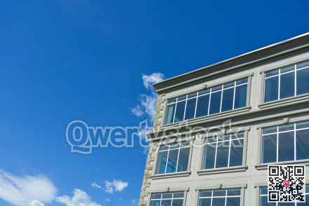 Fragment of the office building by modern architecture on blue sky background