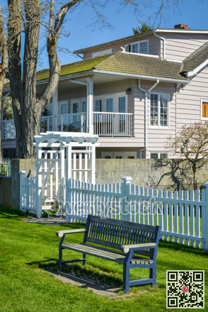 A bench outside of residential house front yard.