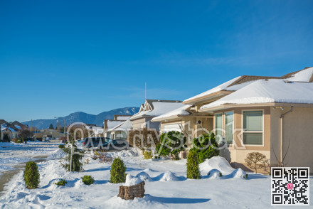 Luxury residential house in snow on winter sunny day