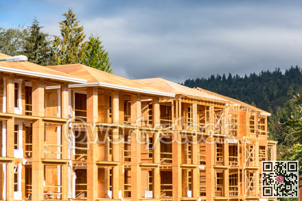 New apartment building under construction on sunny day on blue sky background.