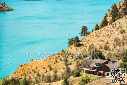 Great view on Kalamaka lake with luxury house and sailboat on the water