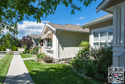 Concrete pathway in front of the houses in residential area on sunny day