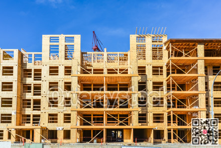 Six storey frame building under construction on concrete foundation bed.
