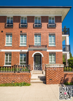 Brand new apartment building with entrance door on sunny day