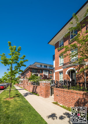 Concrete pathway along the street and new apartment building on sunny day