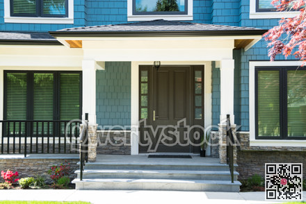 A nice entrance of a luxury house with flight of steps in front.
