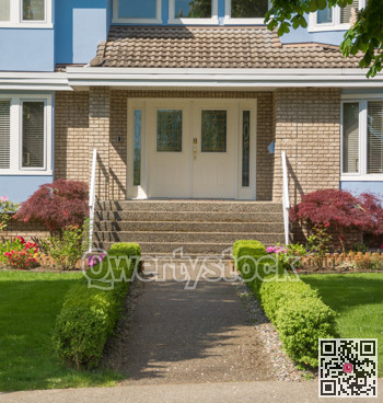 Entrance of family house with small hedges on sides in suburban area