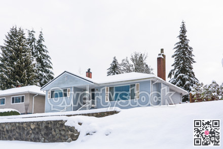 Average North American house in snow on winter cloudy day