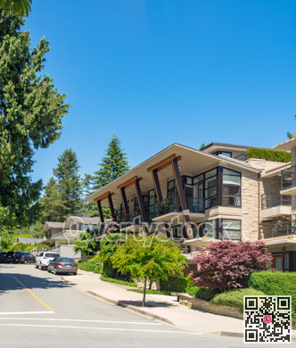 Brand new apartment building with cars parked on the street