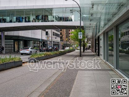 Pedestrian pavement, bike track, and car road in downtown of Vancouver, Canada.