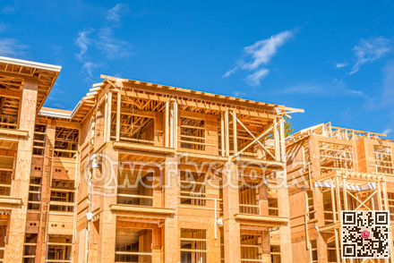 Apartment building under construction on sunny day