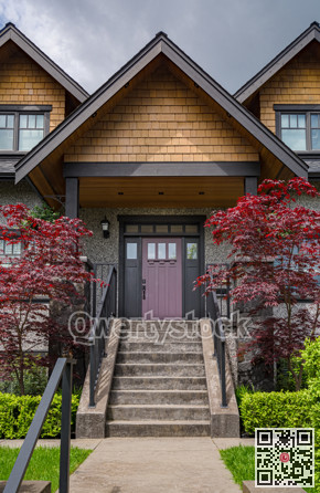 Entrance of luxury residential house with decorative red leave trees