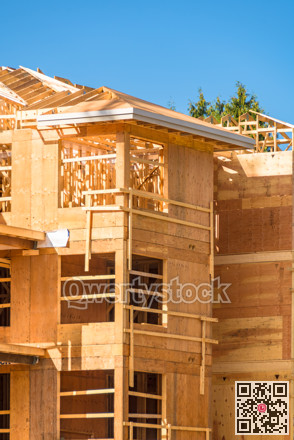 Apartment building under construction on sunny day on blue sky background.