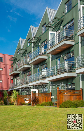 Residential apartment building with green lawn in front