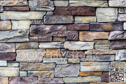 Decorative brown and grey stone setting. Cut stone wall texture.