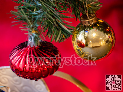 Red onion and golden bauble on Christmas tree brenches