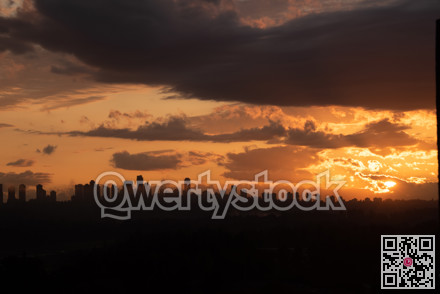 Urban area silhouette on sunset sky background.