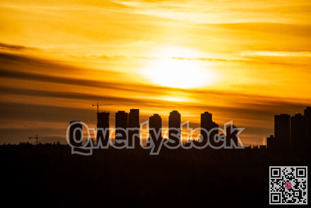 Metrotown silhouette on sunset cloudy sky background.